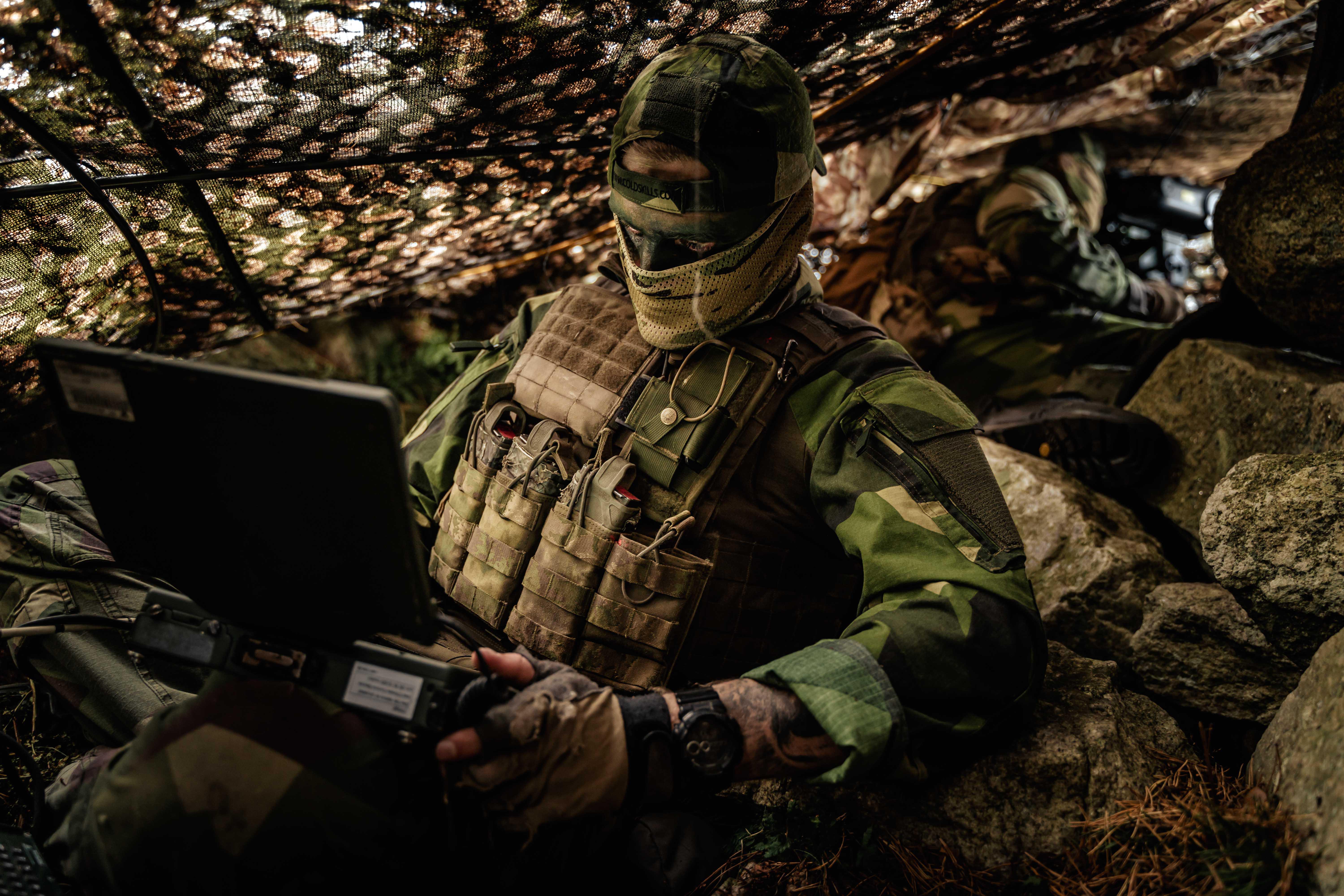 Image shows RAF Regiment using computer inside temporary multi-terrain structure.
